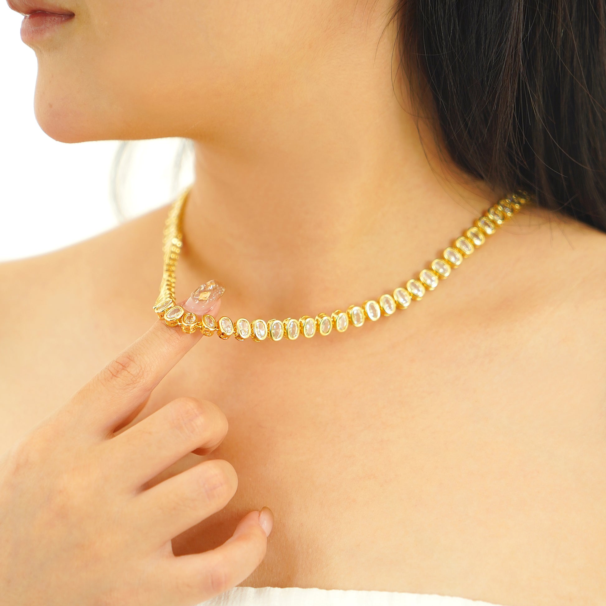 16-inch oval cut tennis necklace featuring sparkling simulated diamond CZs in yellow gold plating