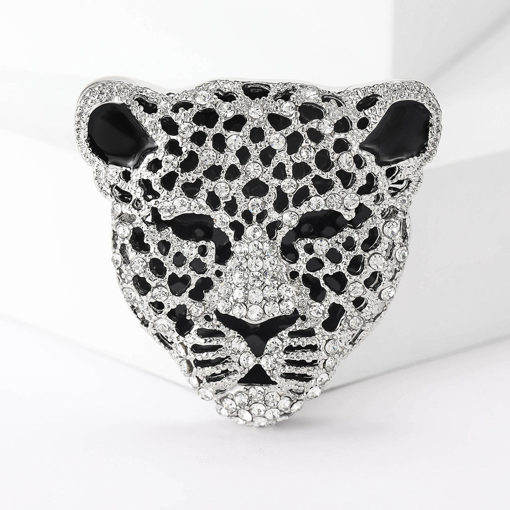 Leopard head-shaped decorative item with rhinestones on a white background