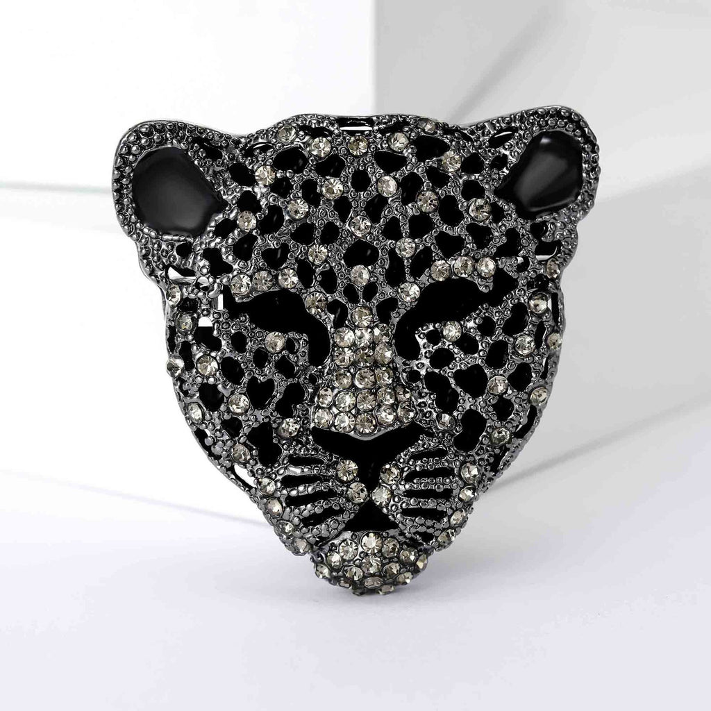 Black and silver leopard head brooch on a white background