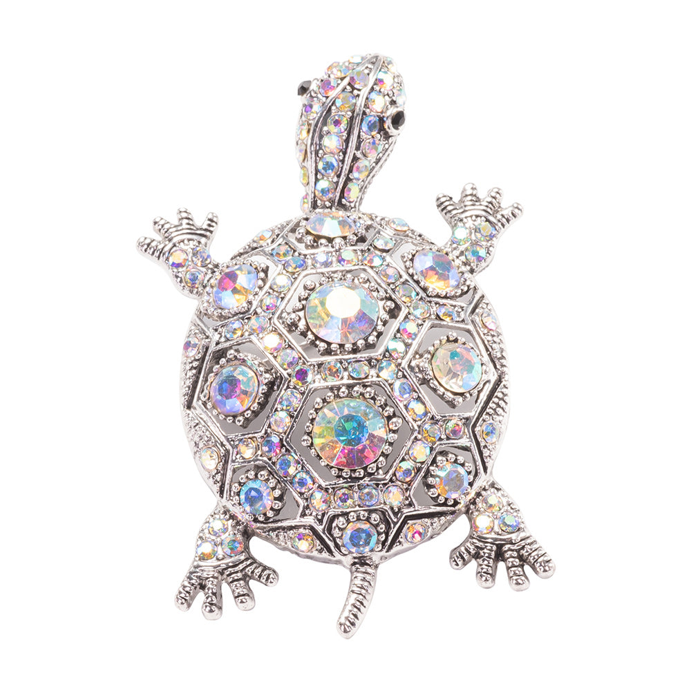 Tortoise-shaped jewelry with colorful gemstones on a white background
