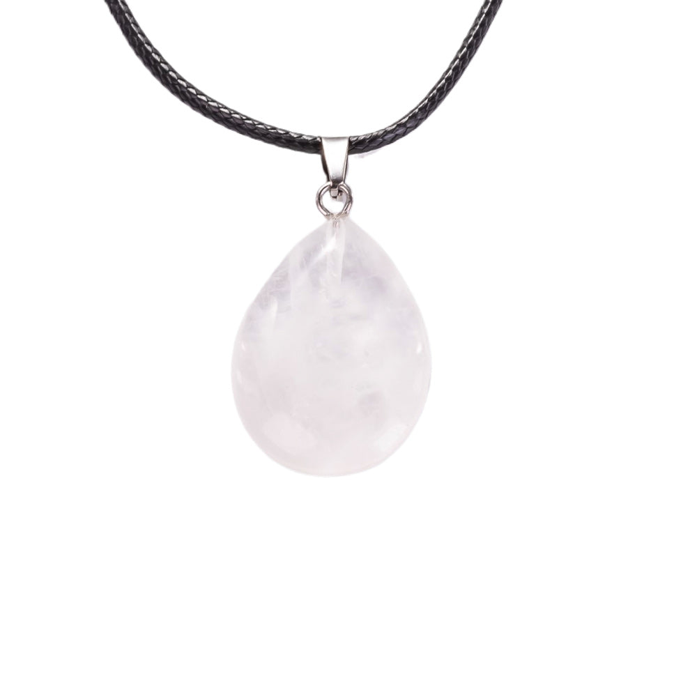 Natural crystal pendant on a black cord against a white background
