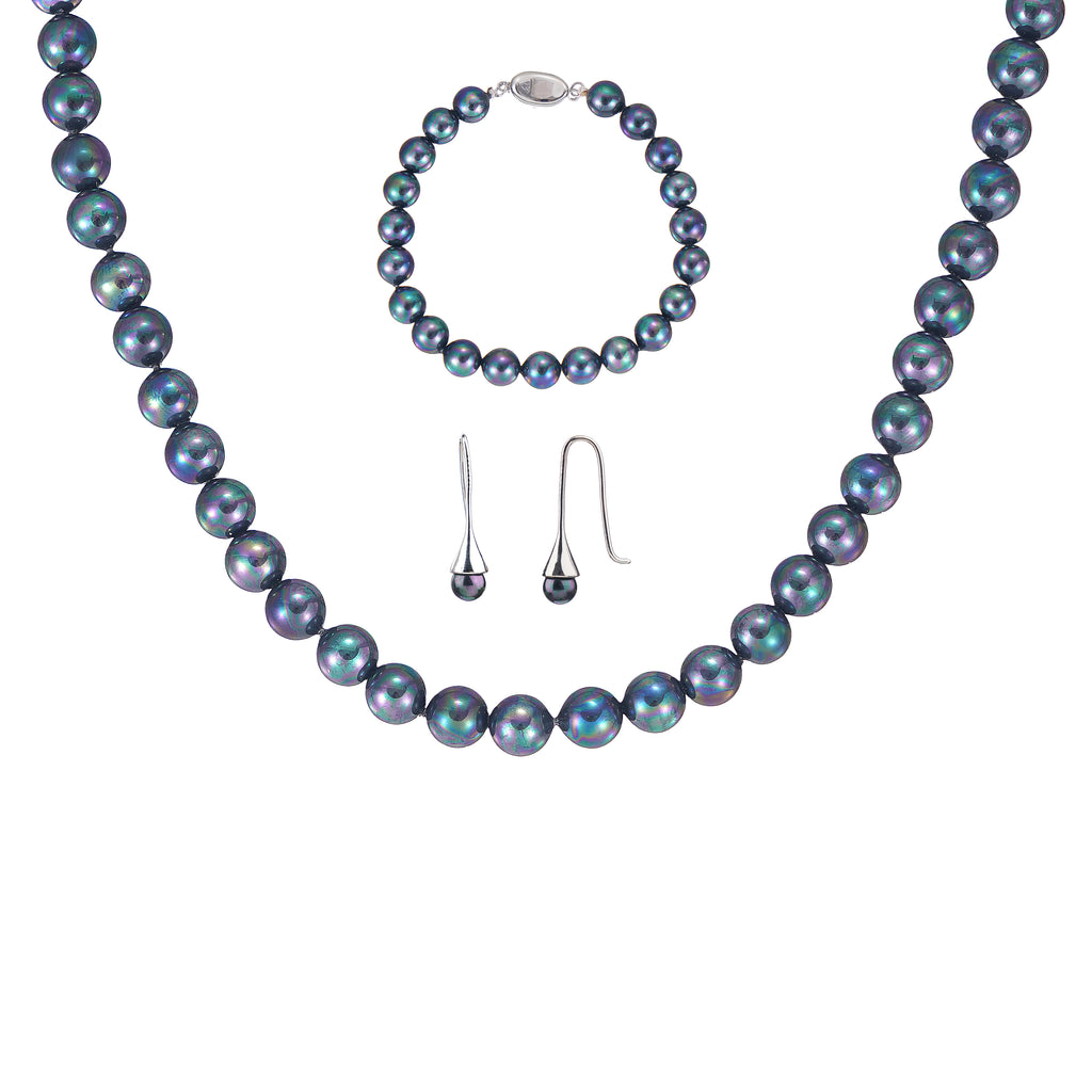 3-piece black peacock shell pearl jewelry set featuring necklace, bracelet, and earrings on a jewelry bus