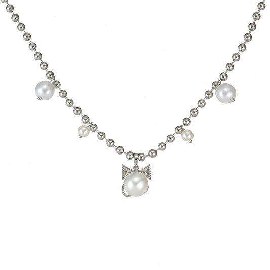 A silver bow necklace with simulated pearls and sparkling CZ stones on a white background.
