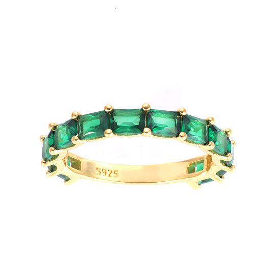 A sterling silver band ring with yellow gold plating and multiple green octagon-cut cubic zirconia stones.