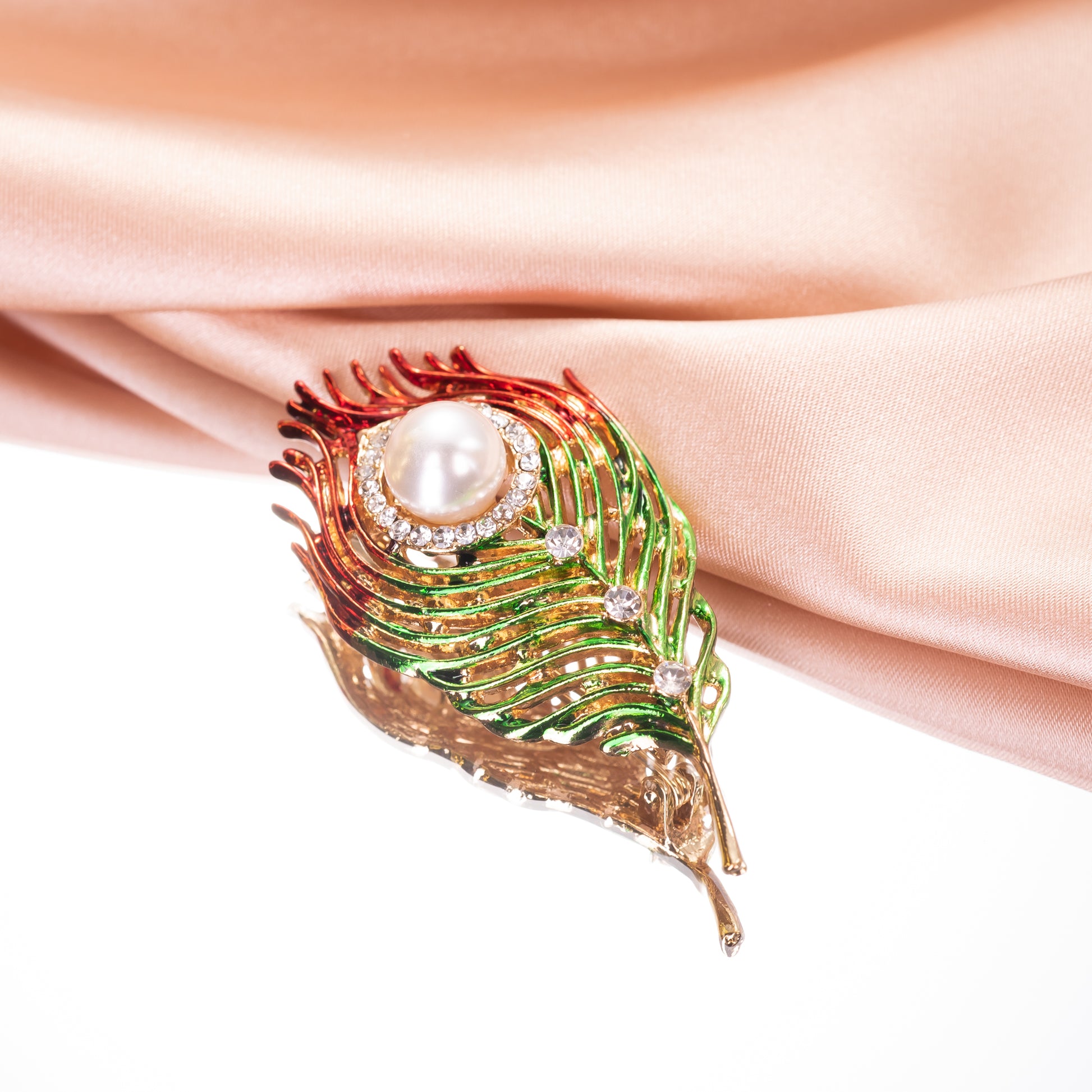 A vibrant peacock feather brooch