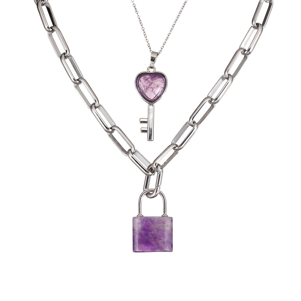 Two silver necklaces with Amethyst heart and lock pendants on a white background
