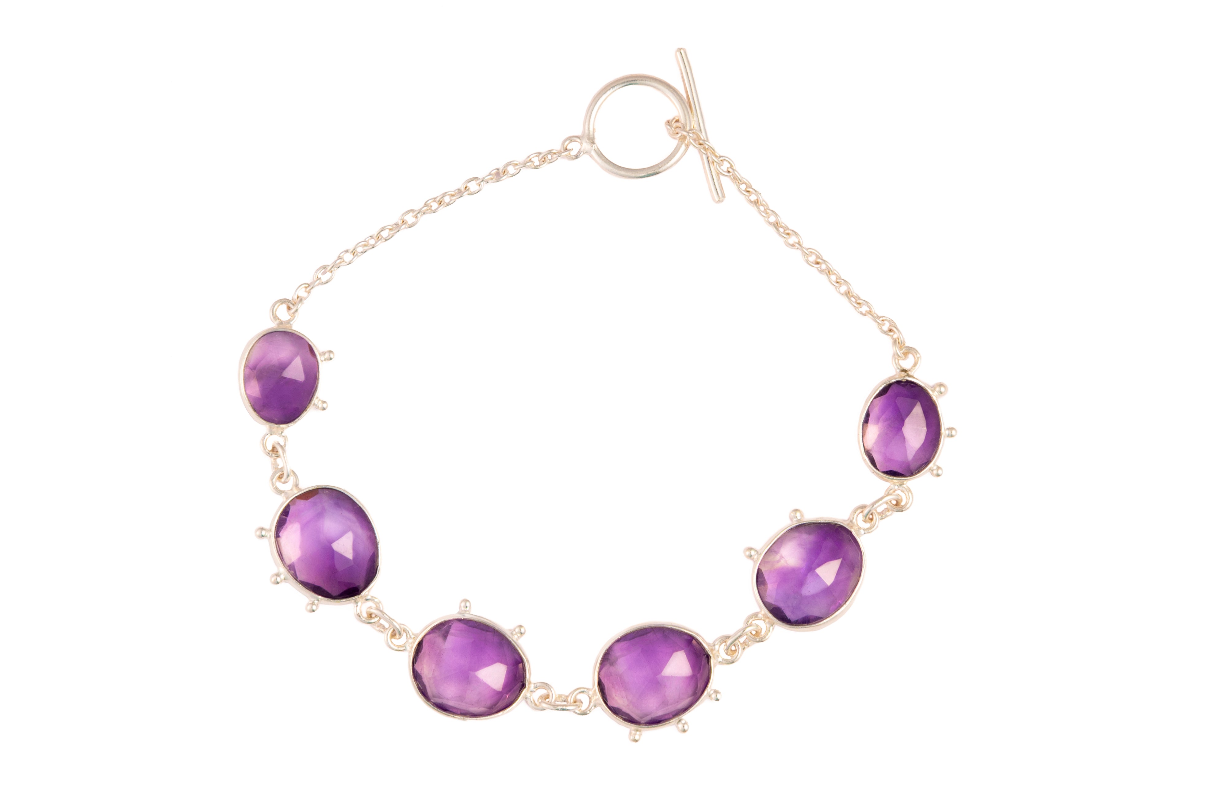 Bracelet with purple gemstones on a white background