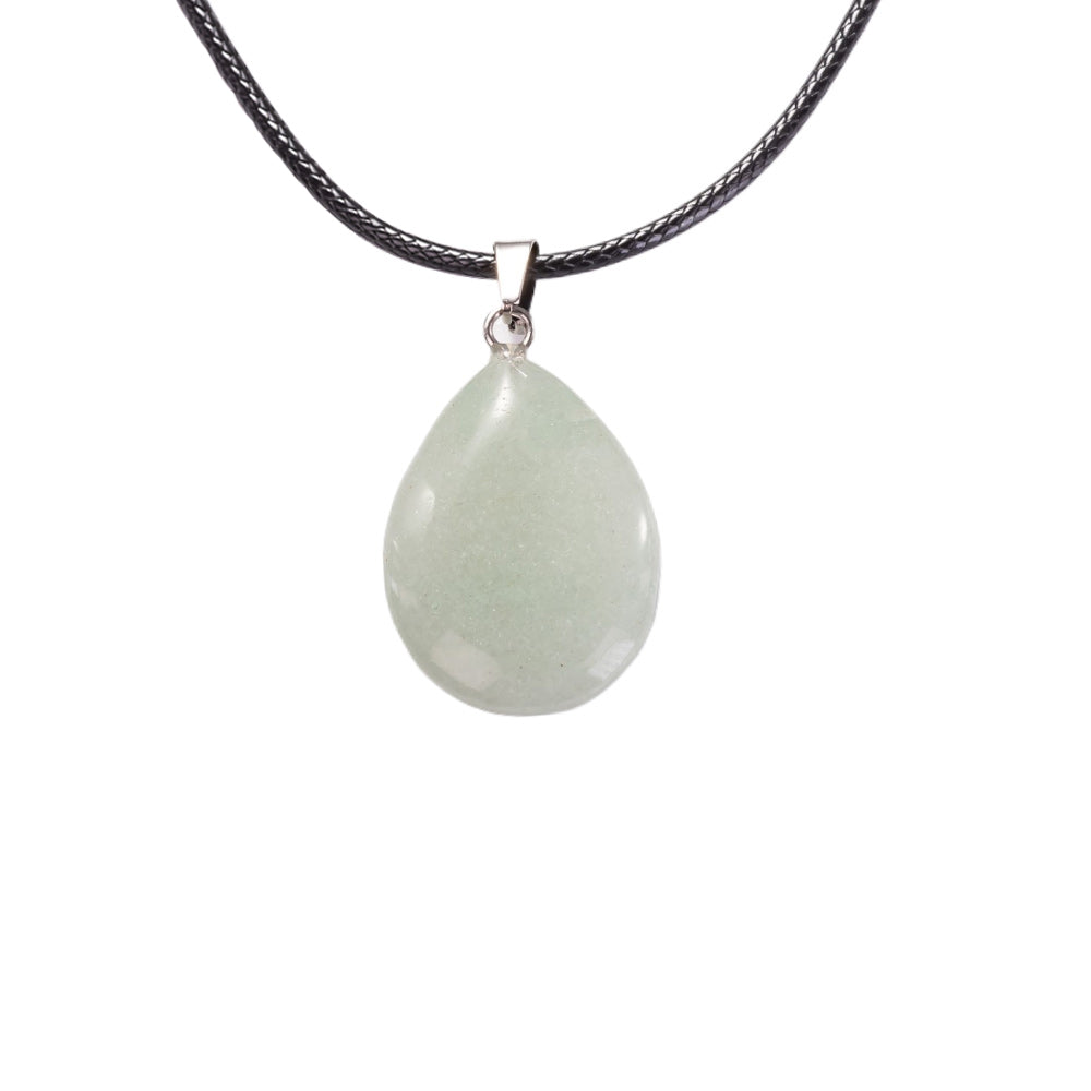 Aventurine pendant on a black cord against a white background