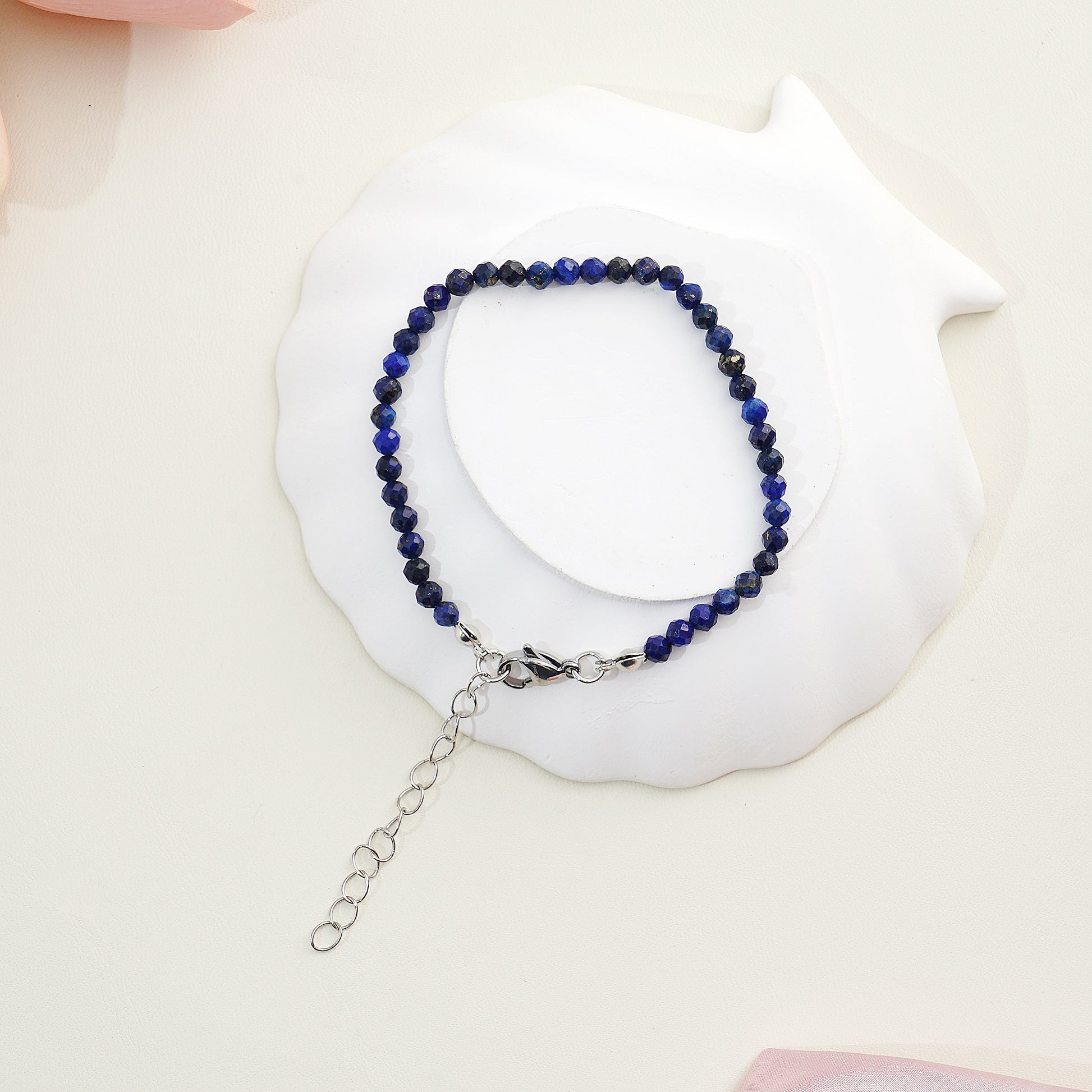 Beaded bracelet with blue stones on a white shell