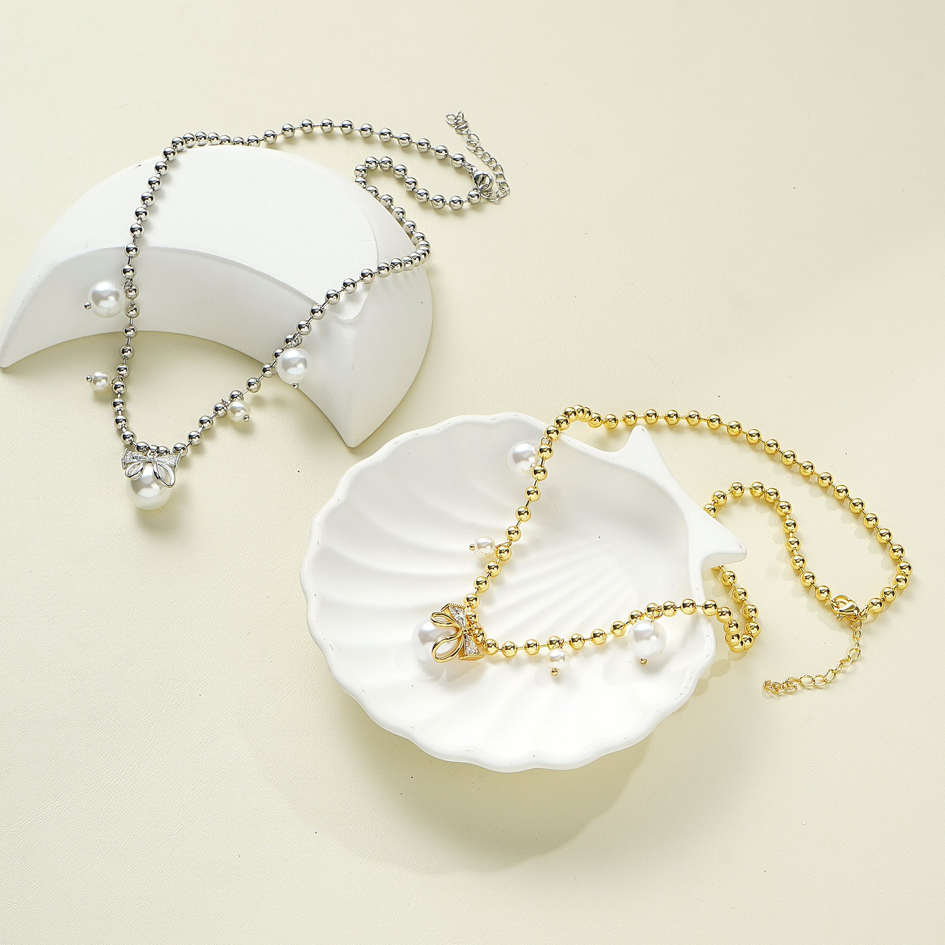 A silver bow necklace with simulated pearls and sparkling CZ stones