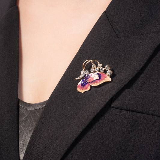 Butterfly-shaped brooch on a black blazer