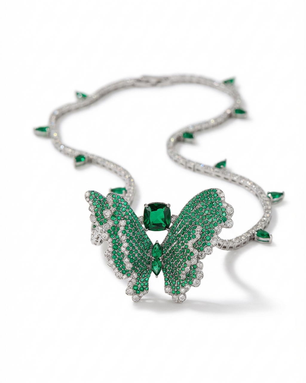 Butterfly-shaped necklace with green gemstones and diamonds on a white background
