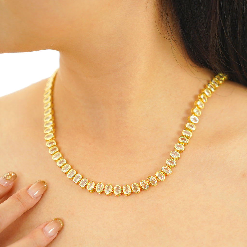 Close-up of a woman wearing an oval CZ tennis necklace