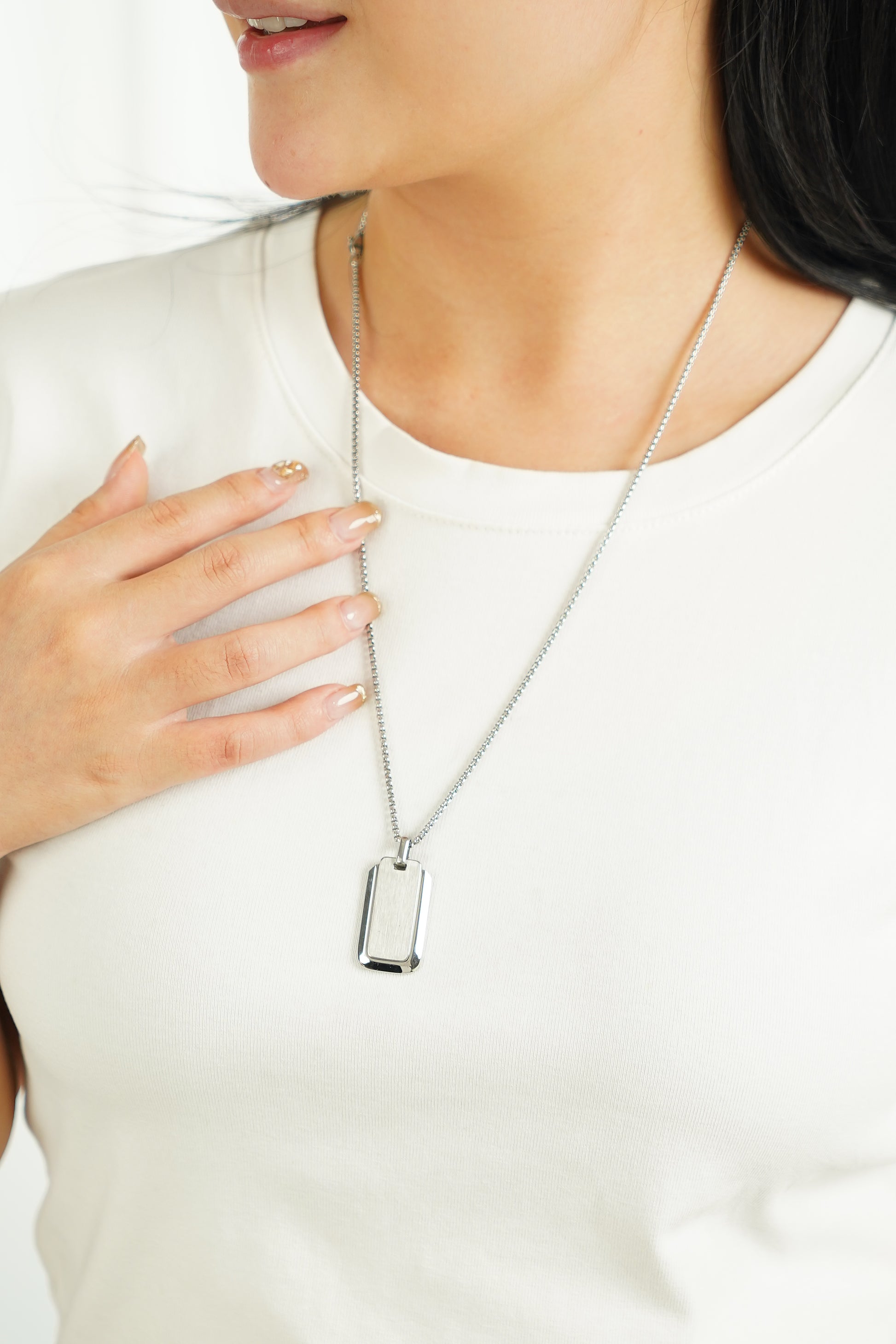 Close-up of the smooth polished white gold finish on the stainless steel dog tag