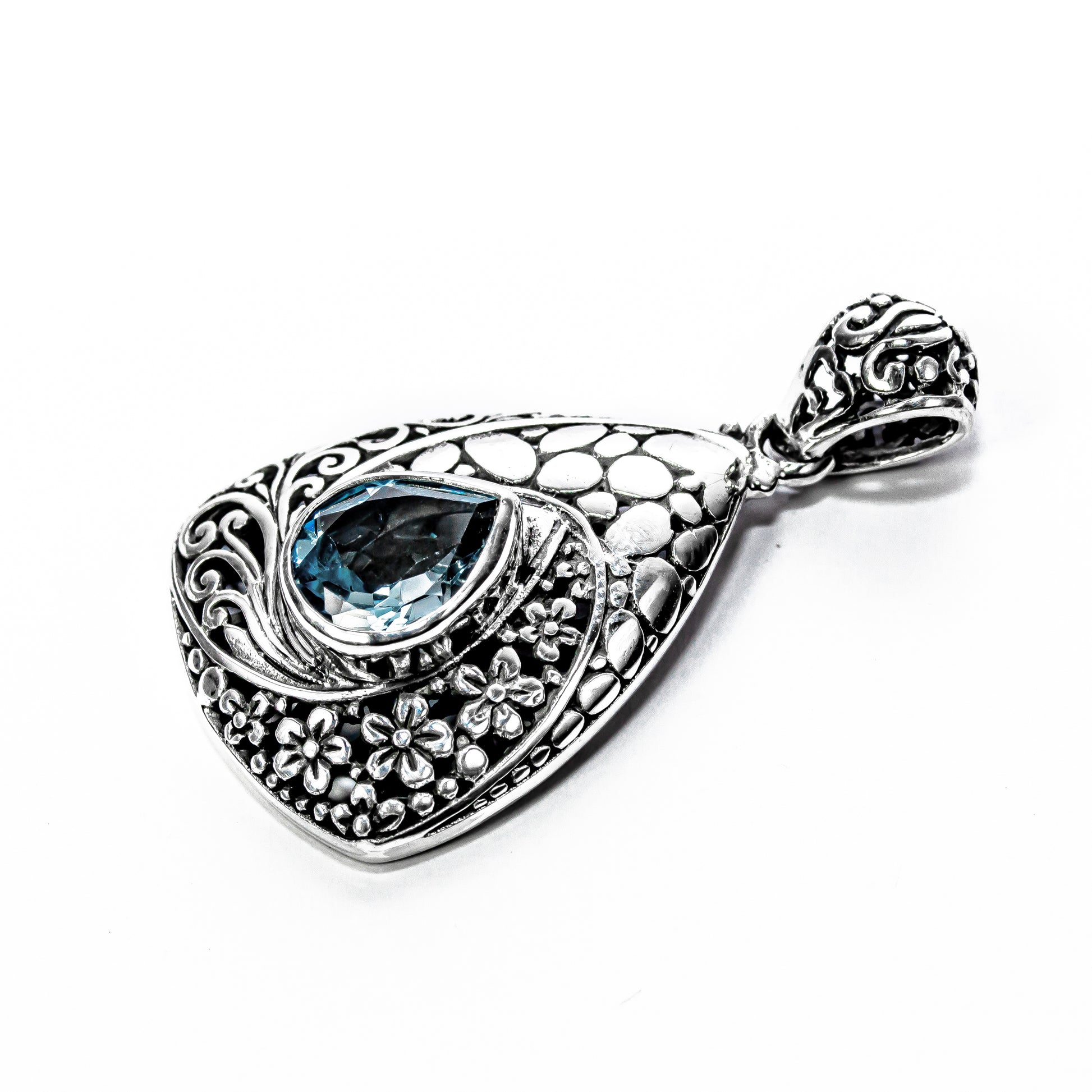 Close-up of the traditional Balinese silver scrollwork and granulation surrounding the blue topaz stone