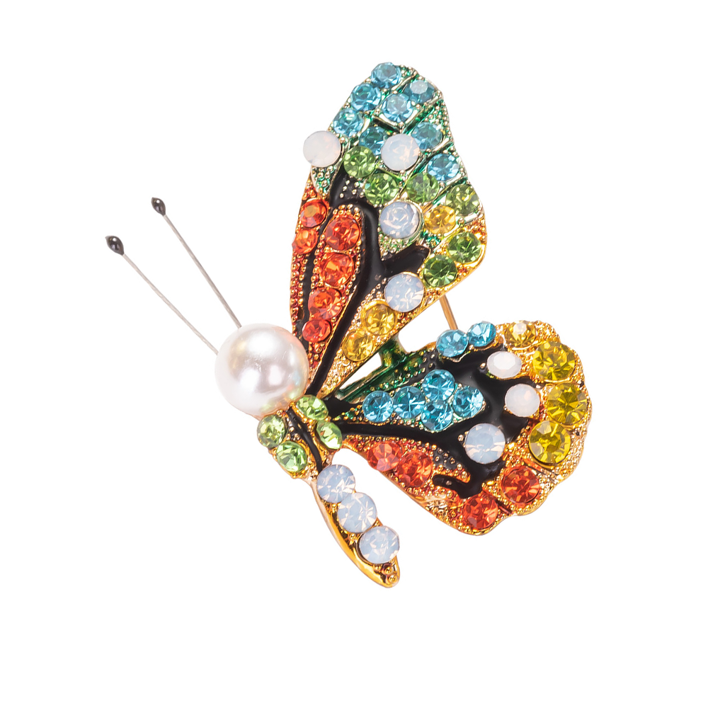 Colorful butterfly brooch with gemstones and a pearl on a white background