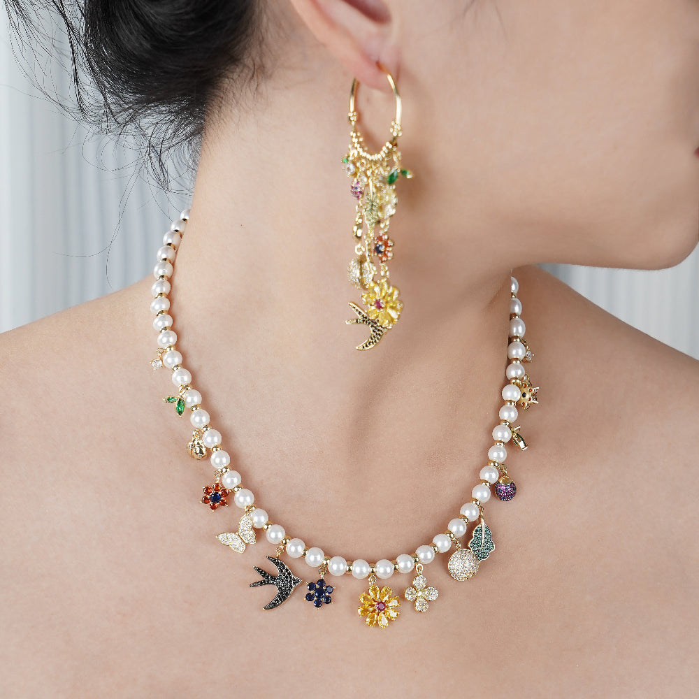 Pearl necklace with colorful charms worn by a person-Stars and Vogue