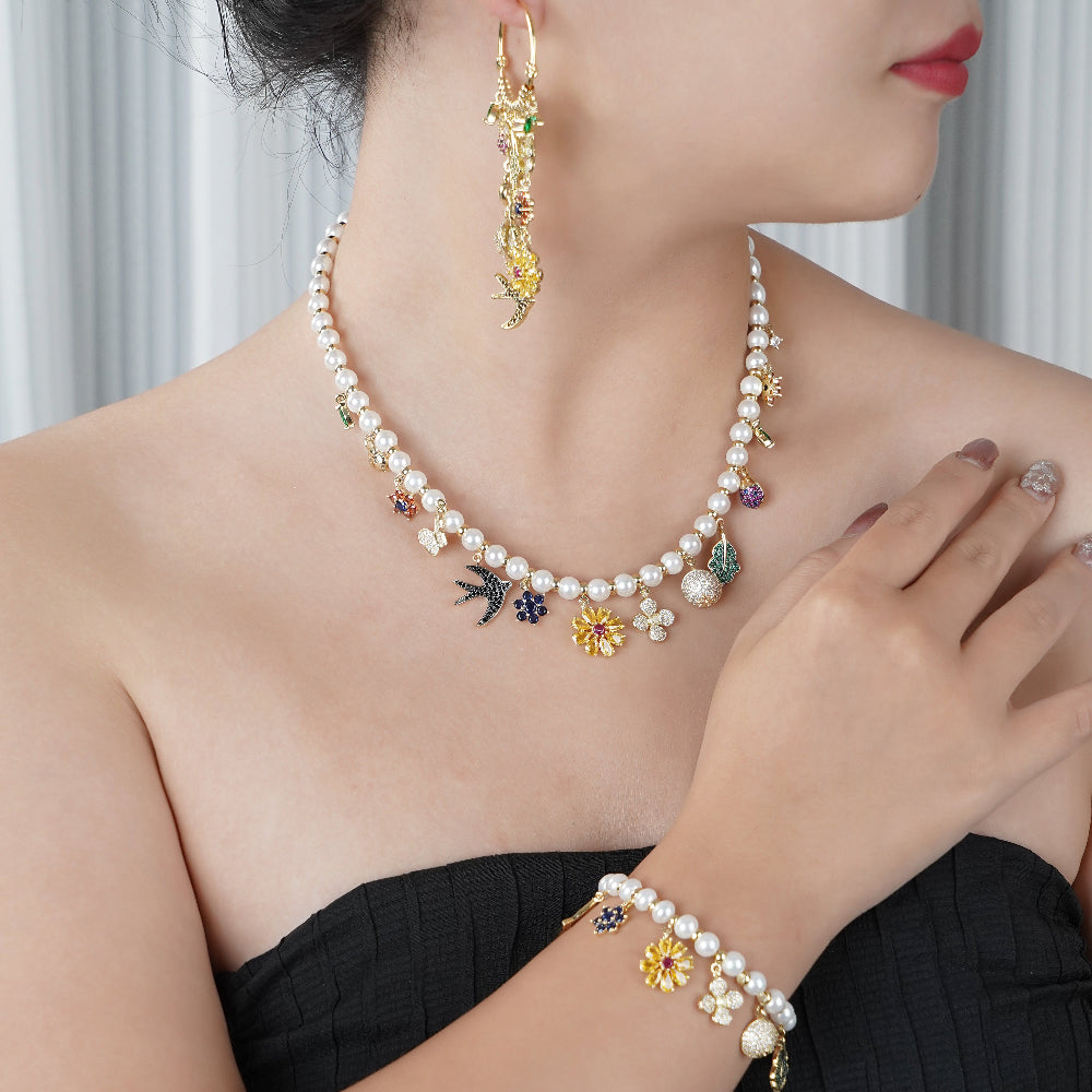 Pearl necklace with colorful charms worn by a model against a neutral background-Stars and Vogue