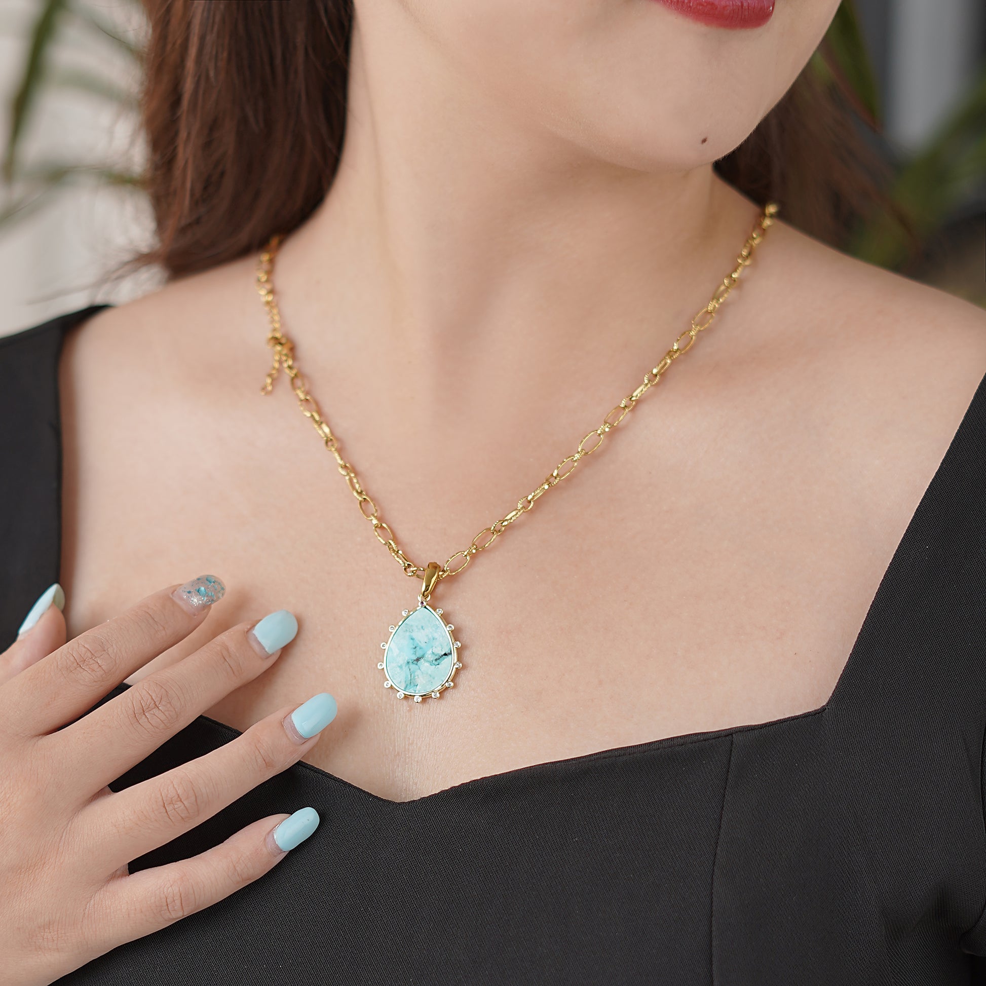 women wearing Gold necklace with a aqua Lapis Gemstone pendant