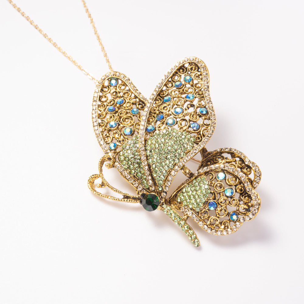 Butterfly-shaped pendant with crystals on a white background