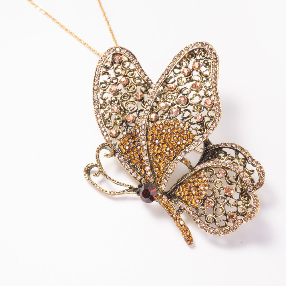Butterfly-shaped pendant with intricate design on a white background
