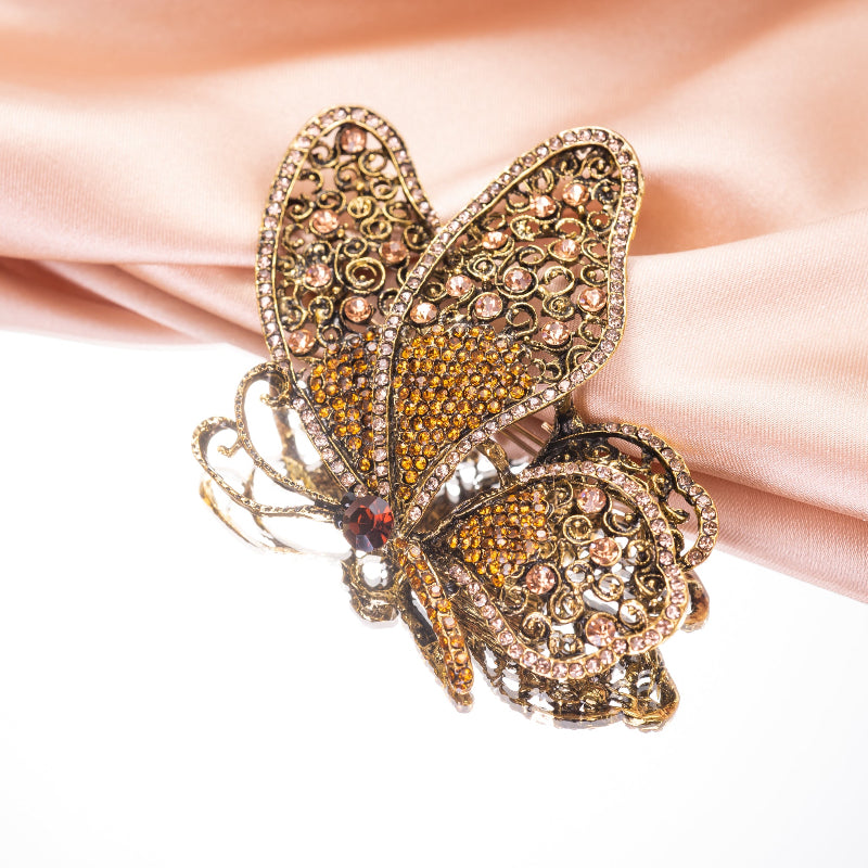 Butterfly-shaped jewelry with intricate design on a white background