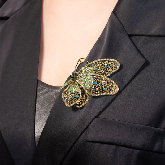 Butterfly brooch with crystal on a black blazer