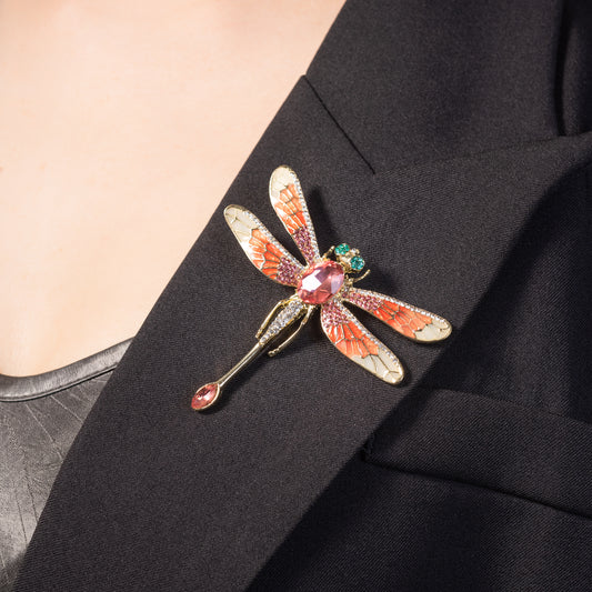 Decorative dragonfly brooch on a black suit lapel