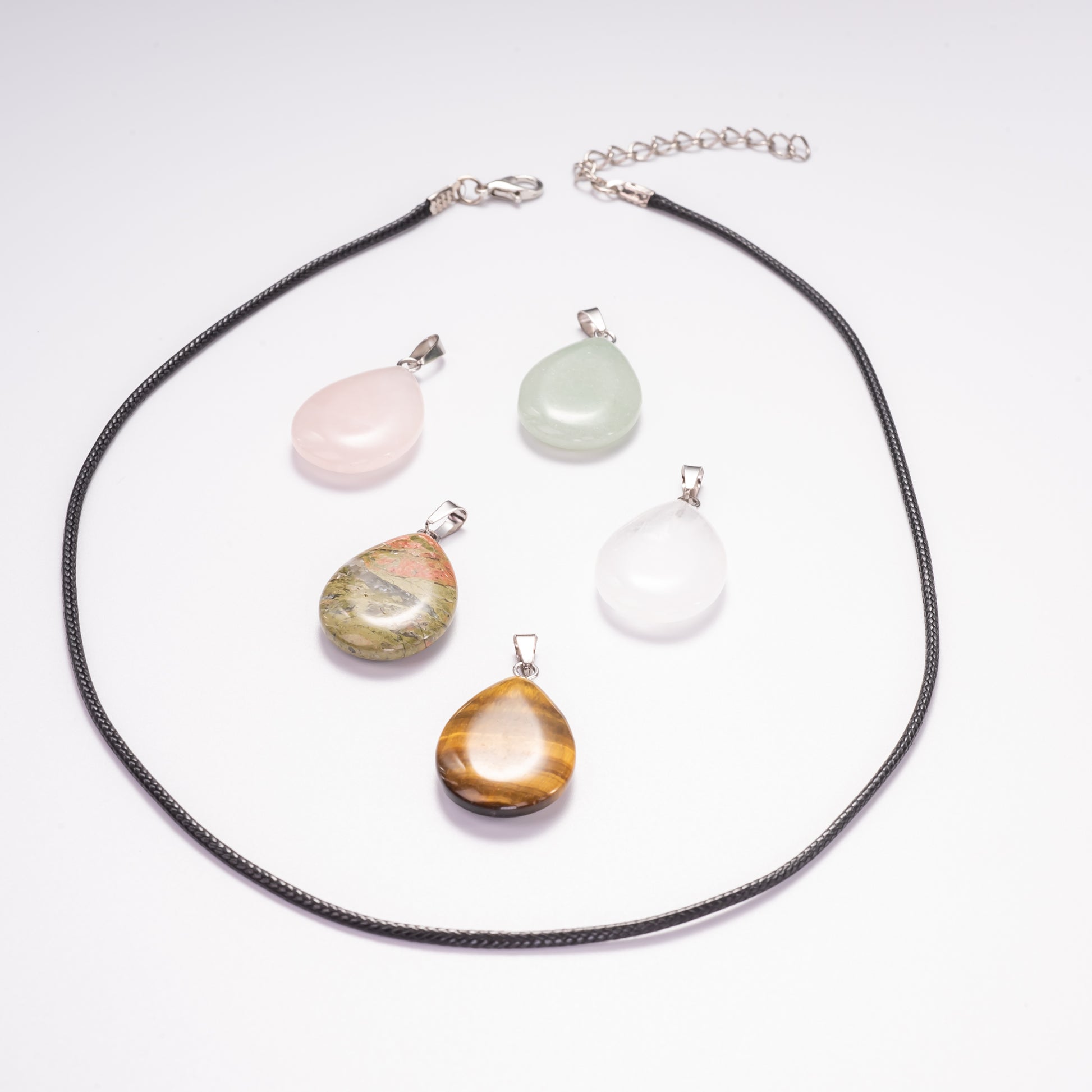 Necklace with multiple teardrop-shaped stone pendants on a white background