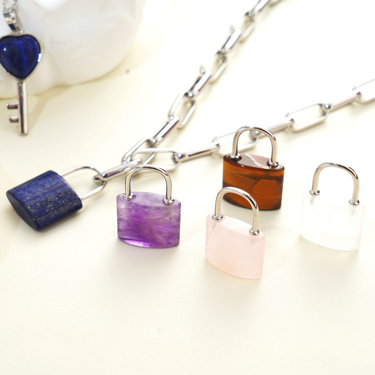 Colorful padlock-shaped charms on a chain against a white background