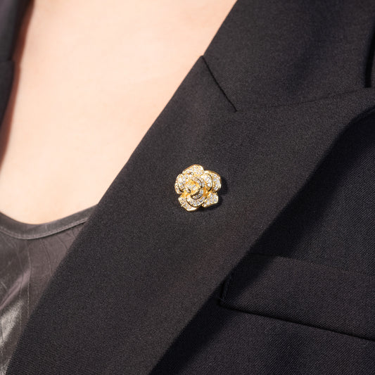 Gold brooch on a black suit jacket