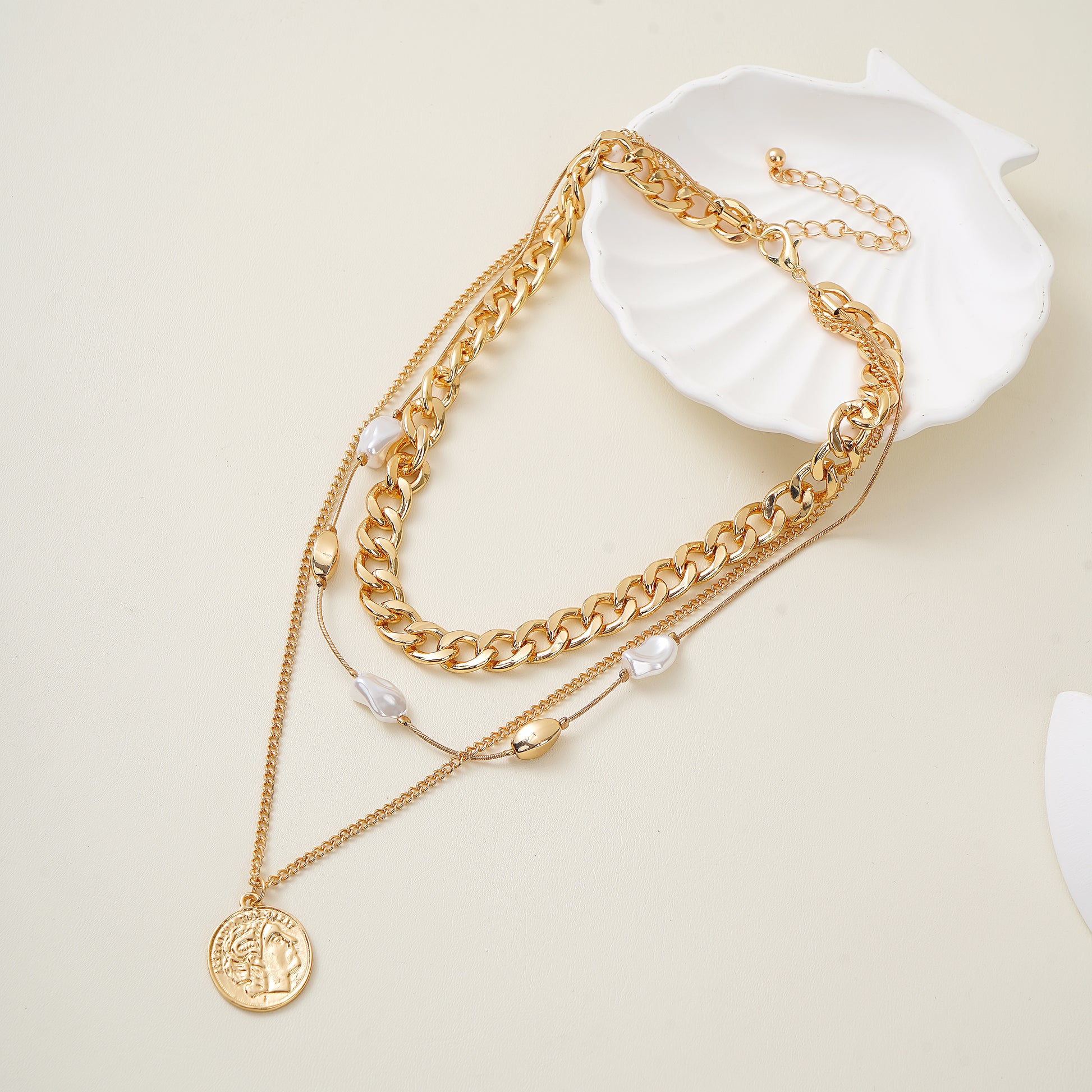 Gold chain necklace with a coin pendant