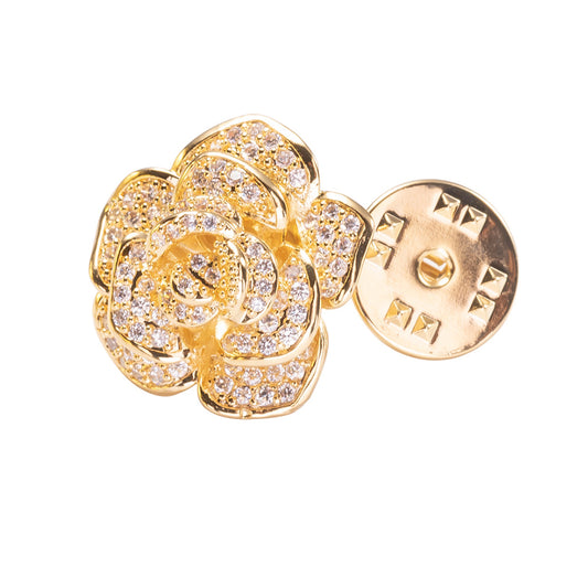 Gold flower-shaped earring with clear gemstones on a white background