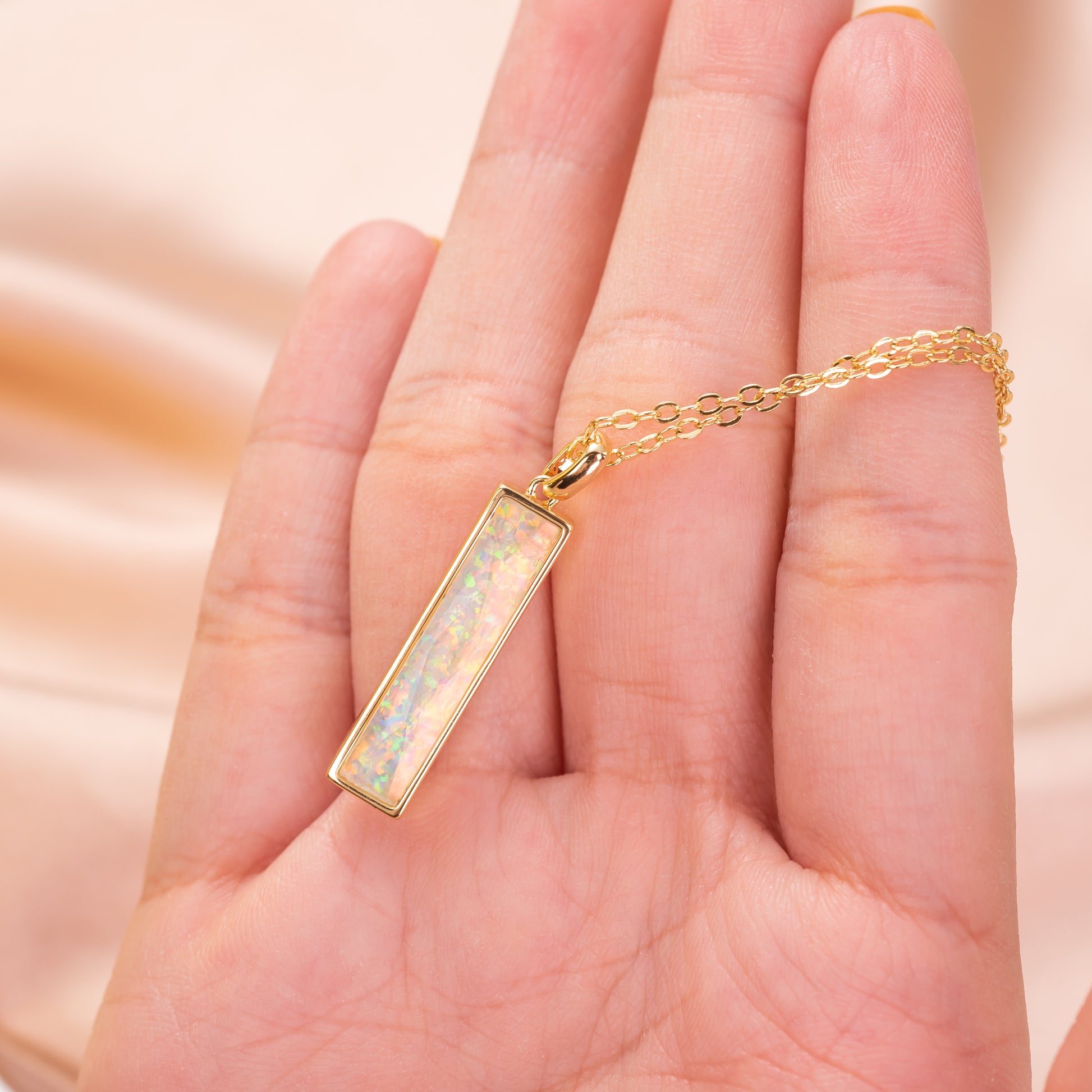 Gold necklace with a bar pendant 