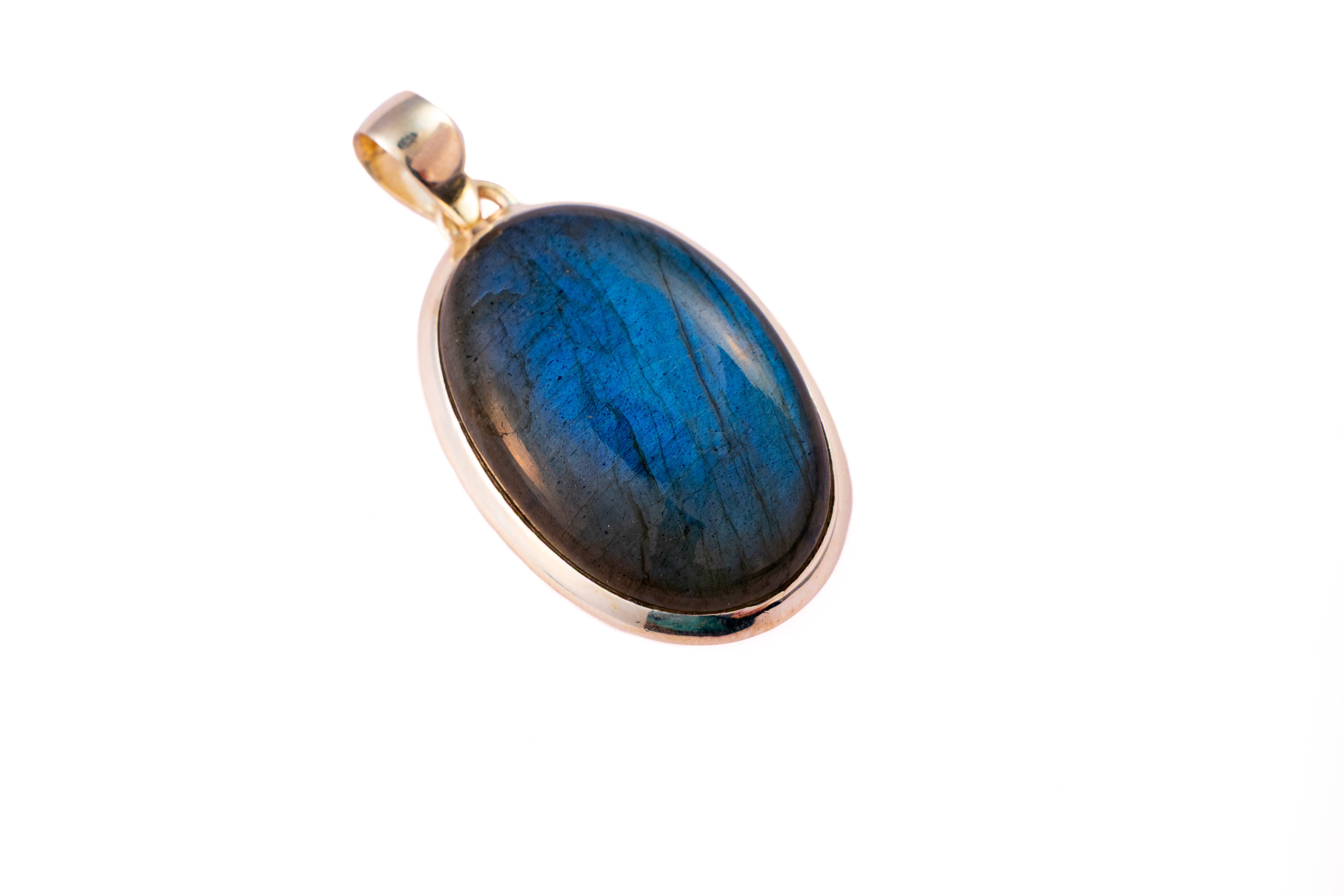 A Labradorite pendant against a white background