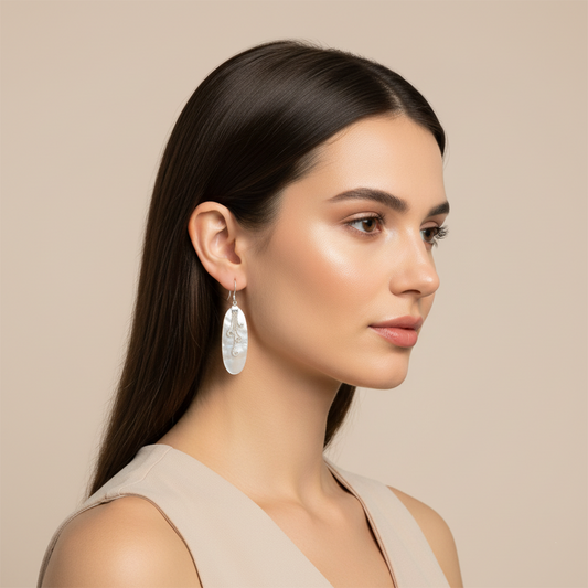  Model wearing Bali handmade elongated shell earrings, showing how the design elongates the neck