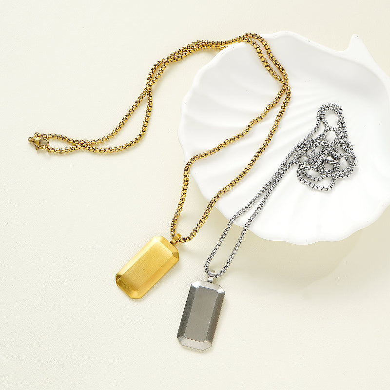 Two necklaces with gold and silver dog tags on a white background
