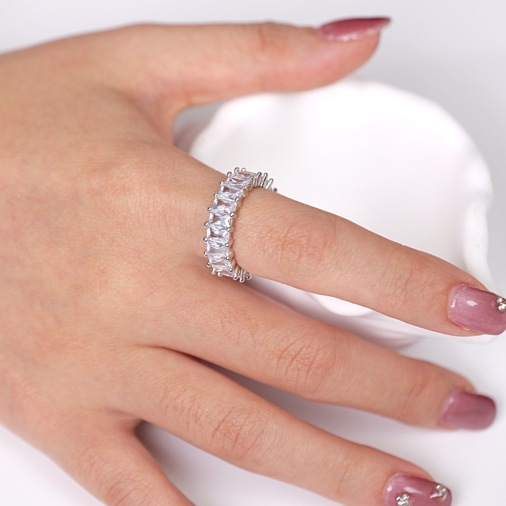 octagon-cut stones and 925 silver setting on an eternity band ring