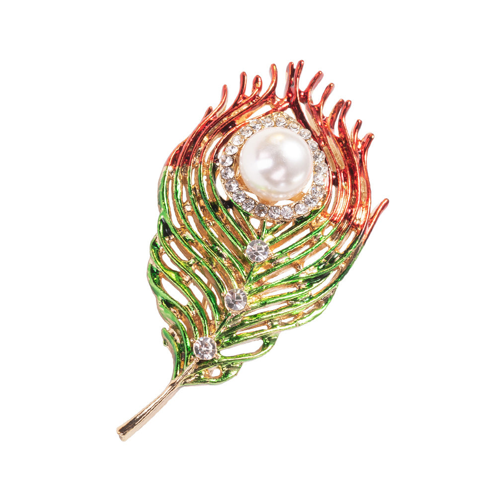 A brooch pin with enamel, freshwater pearl, and crystal embellishments designed to resemble a peacock feather.
