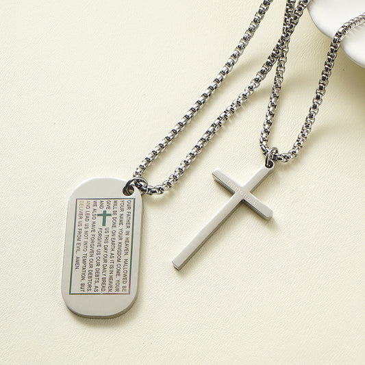 Stainless steel dog tag necklace engraved with the Lord's Prayer and a separate cross overlay.