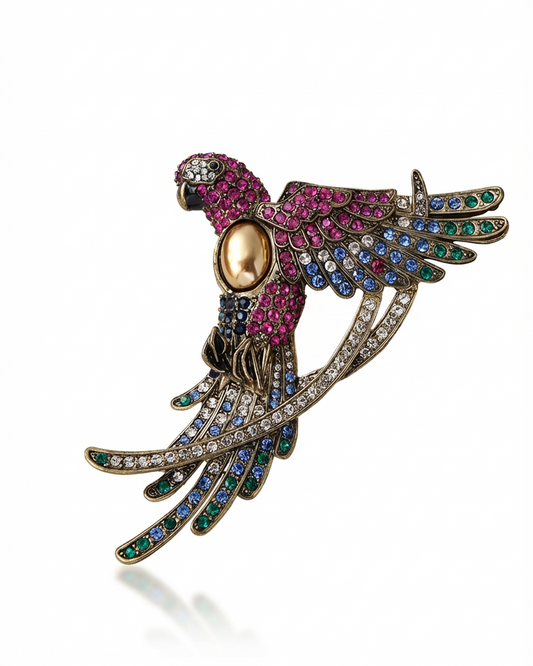 Decorative parrot brooch with gemstones on a white background