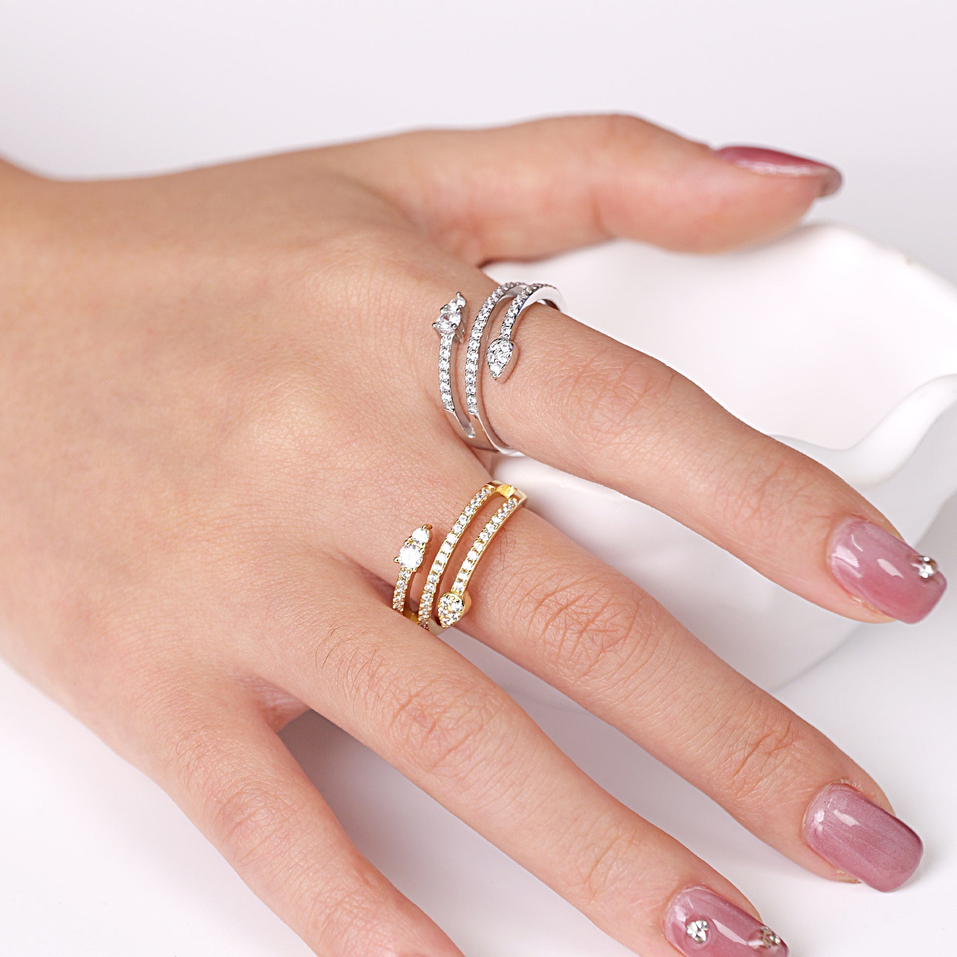 A sterling silver bypass ring with a snake design and sparkling cubic zirconia accents.