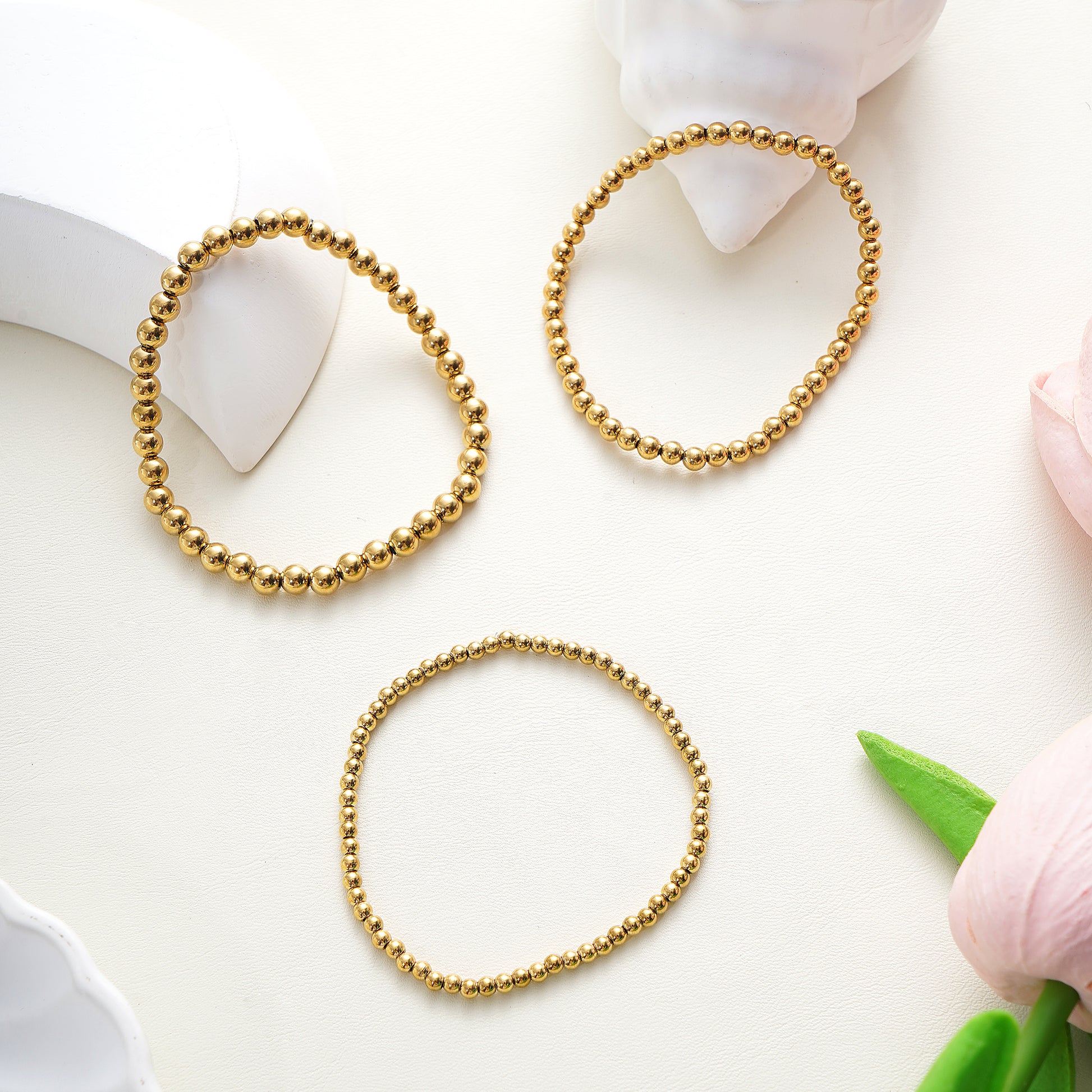 Three gold beaded bracelets 