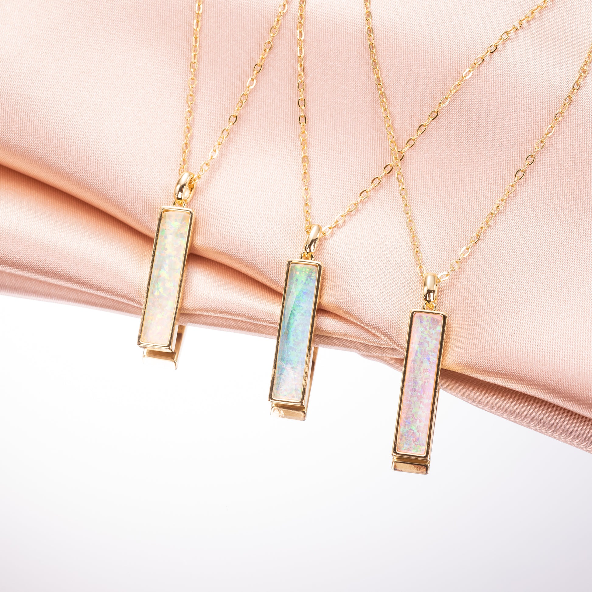 Three gold necklaces with opal pendants