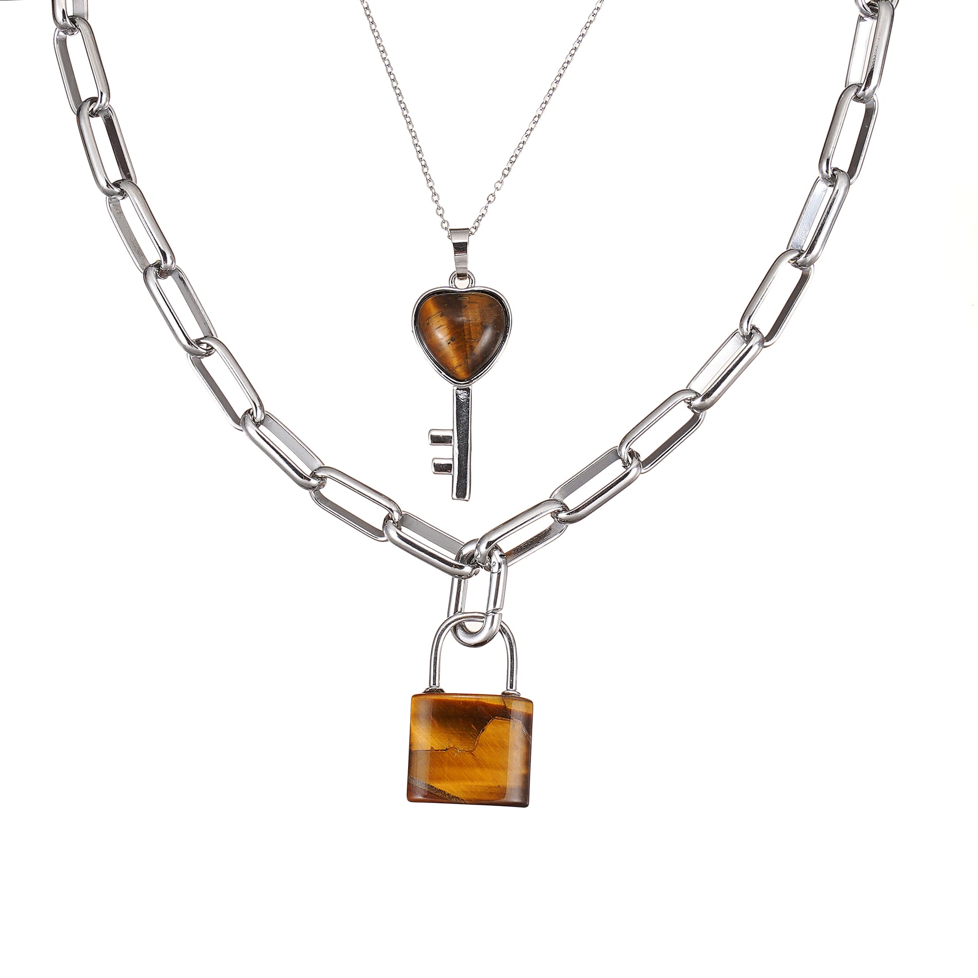 Two silver necklaces with Tiger Eye heart and lock pendants on a white background