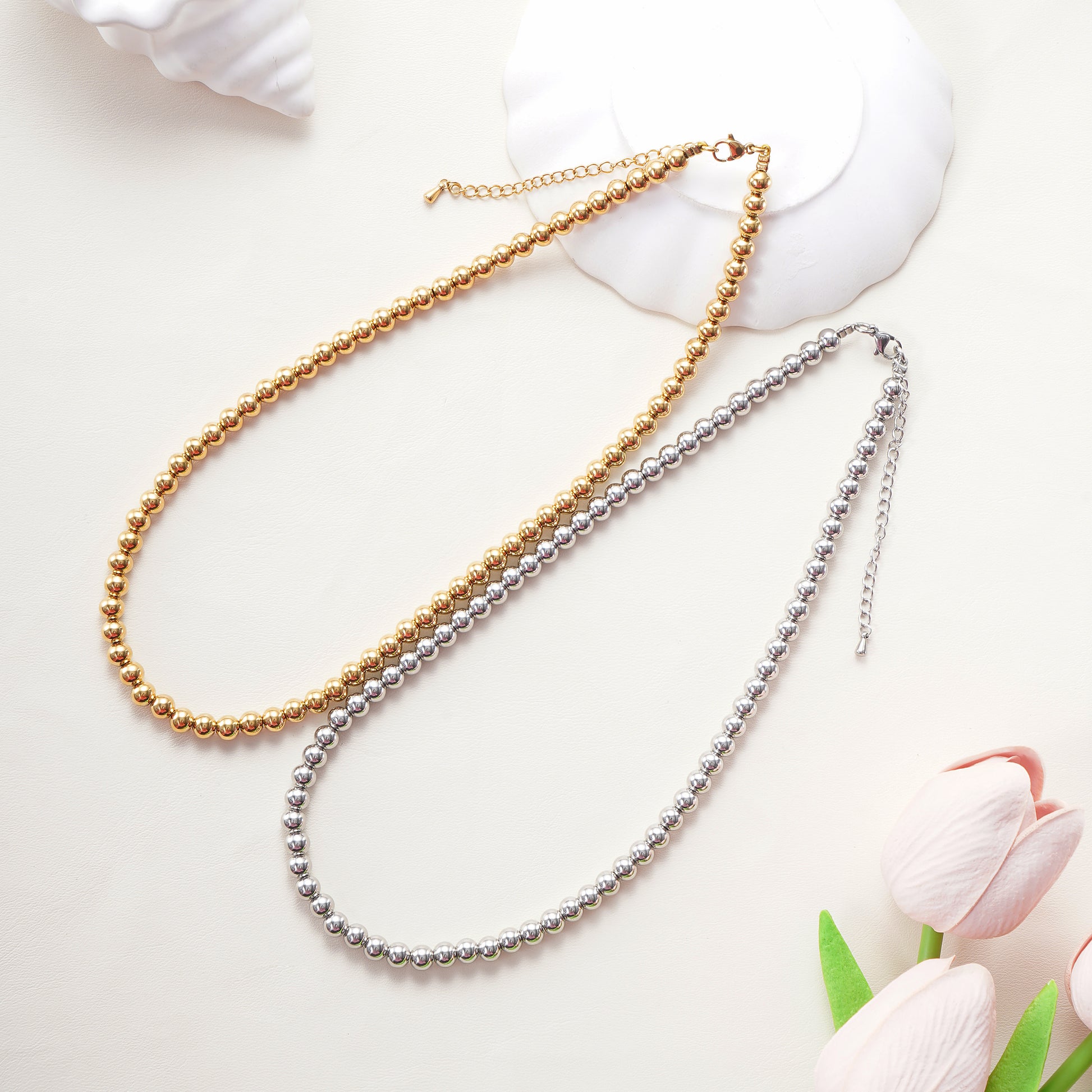 Two pearl necklaces, one gold and one silver