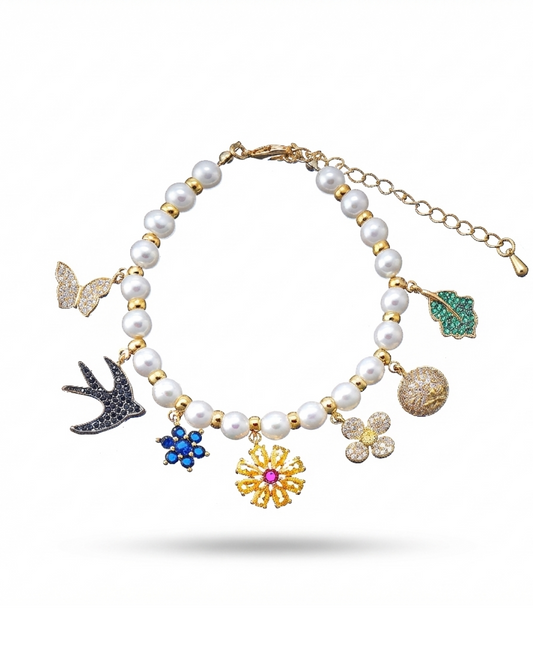 Pearl bracelet with floral and butterfly charms on white background-Stars and Vogue