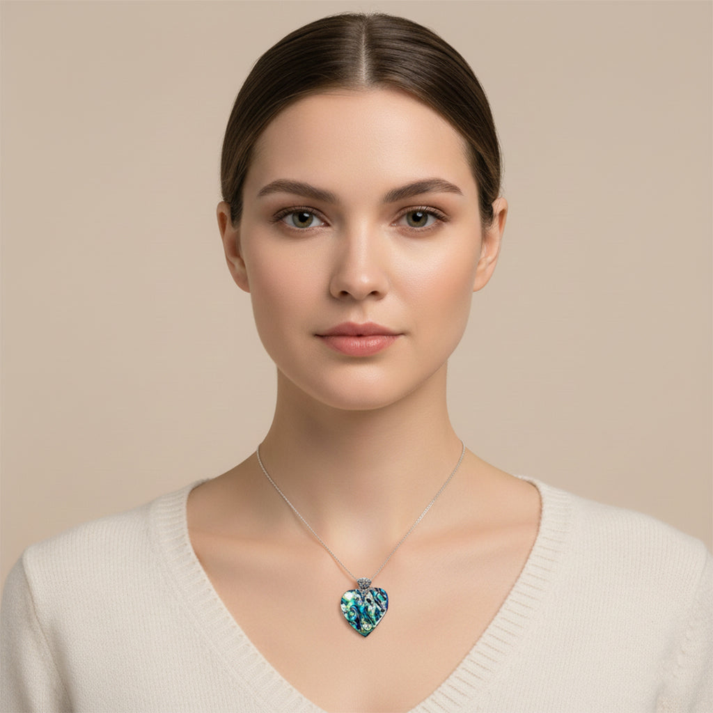 Woman wearing a necklace with a heart-shaped blue pendant