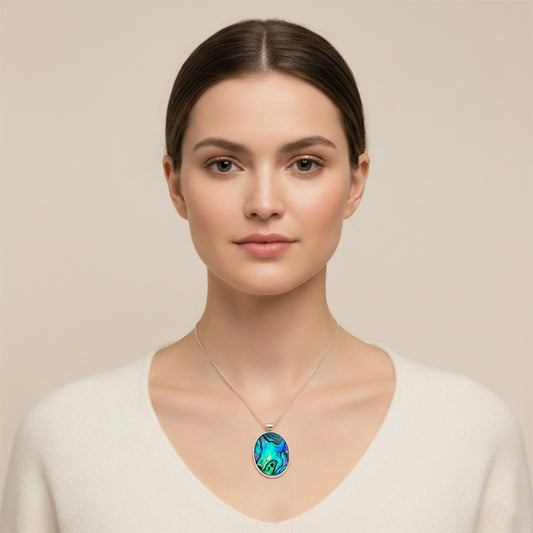 Woman wearing a necklace with an oval pendant on a beige background