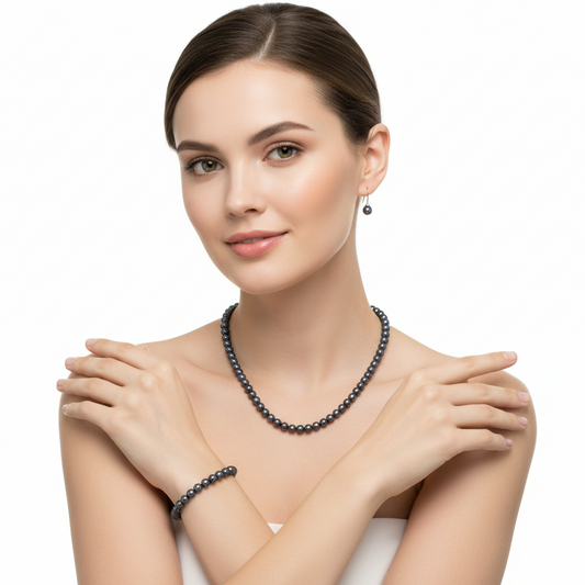 a woman wearing the 18-inch black peacock pearl necklace and matching 6mm stud earrings